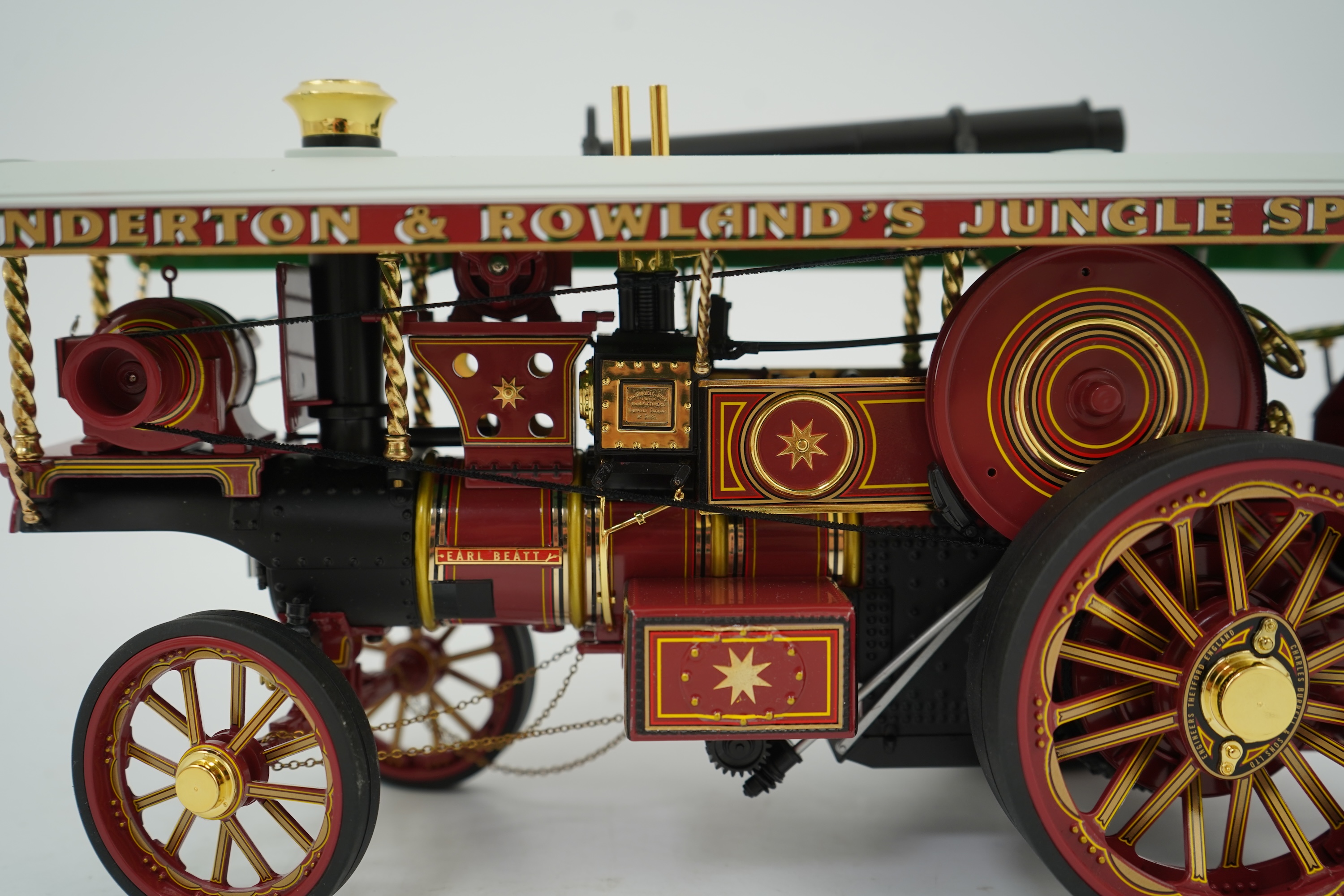 A Midsummer Models Ltd. 1:24 scale model of a Burrell Showman’s Engine, Earl Beatty, in ‘Anderson & Rowland’s Jungle Speedway’ livery, missing the original card box, but with an oak and Perspex display case